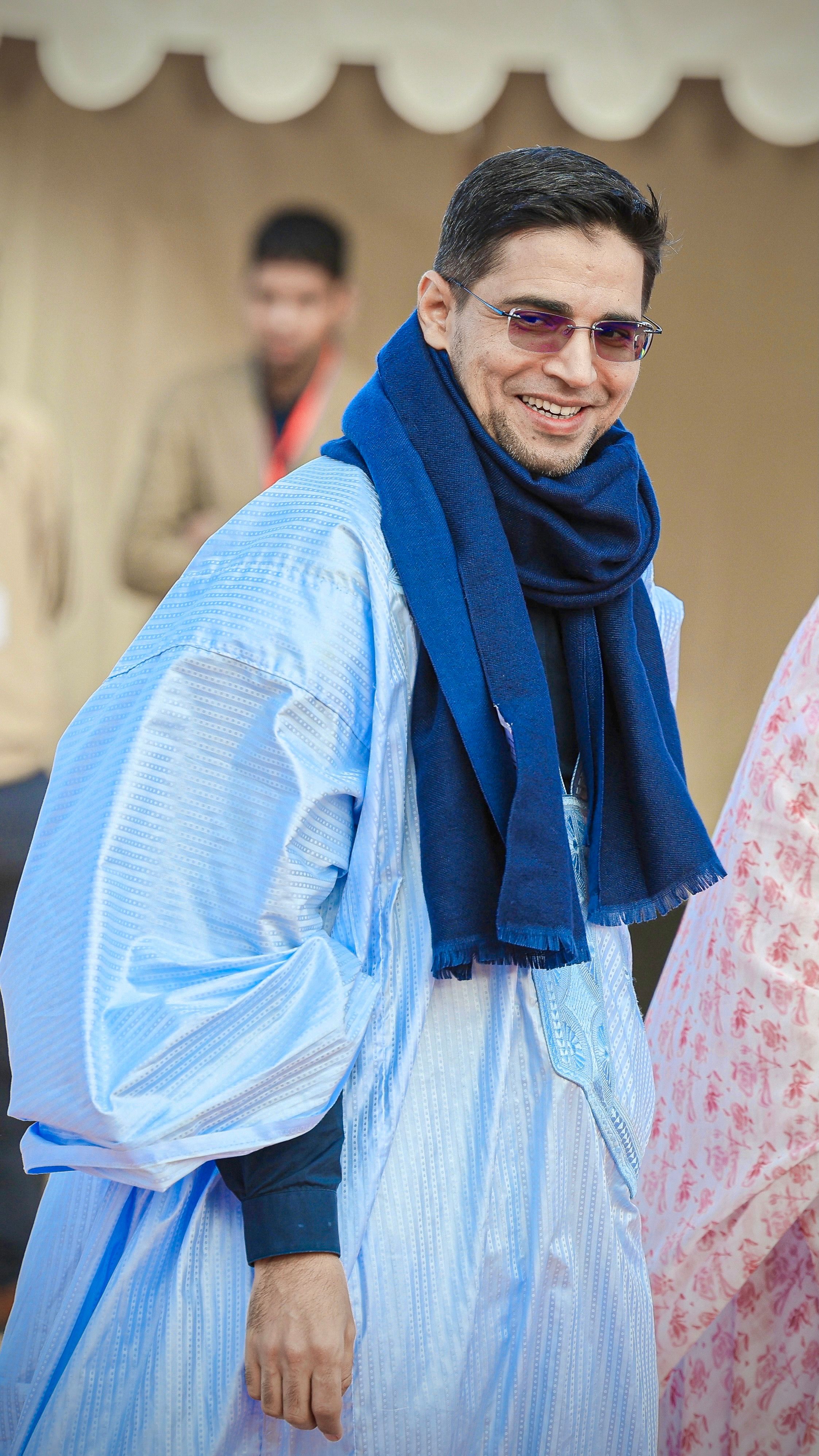 Smiling Man in Traditional Blue Robe Outdoors · Free Stock Photo