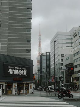 View of Tokyo Tower from the streets of Minato, capturing urban life and architecture.