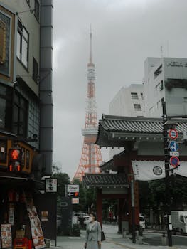 A bustling Tokyo street scene featuring the iconic Tokyo Tower and traditional architecture.