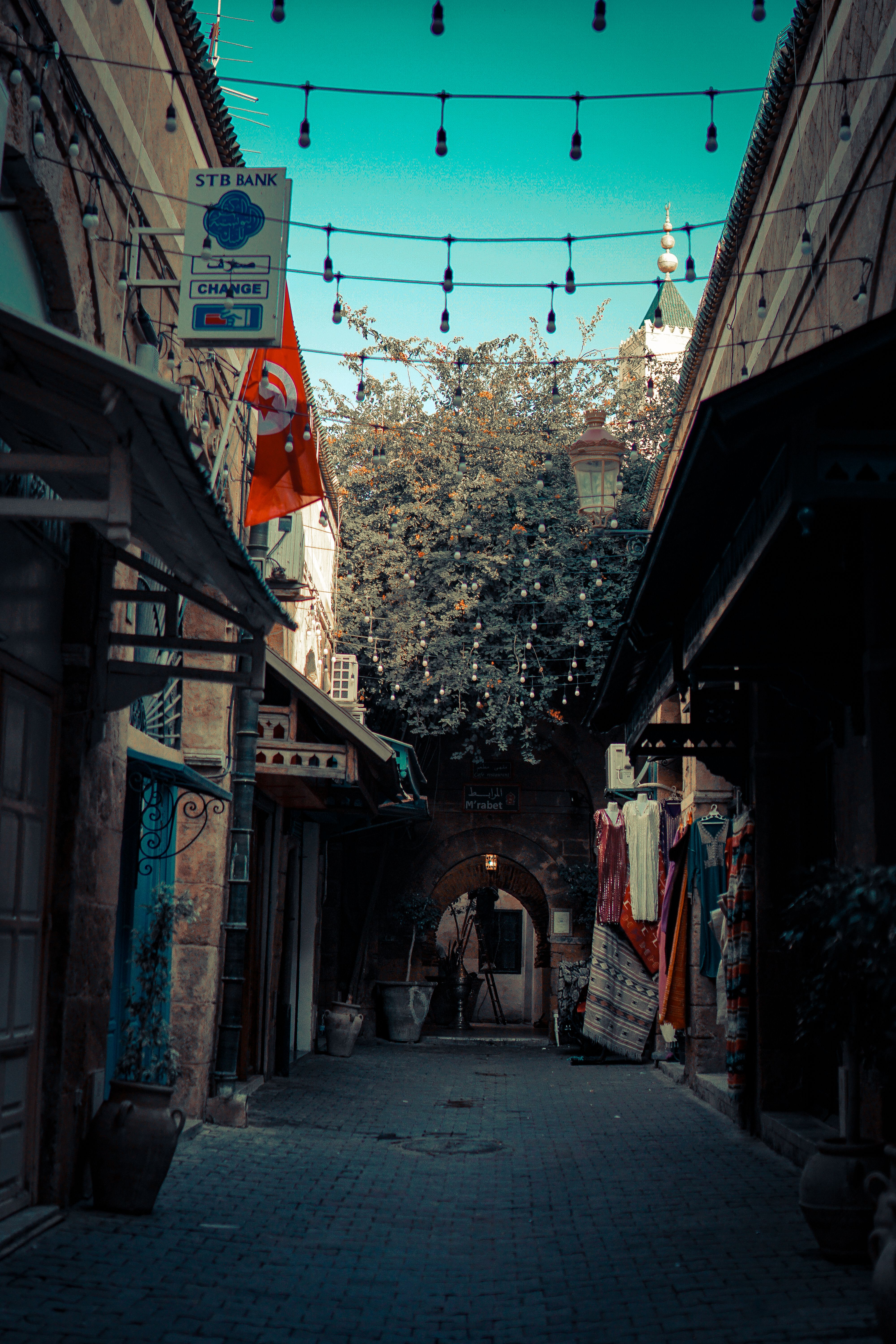 Explore a picturesque alley in Turkey, adorned with vibrant textiles and ornate architecture.
