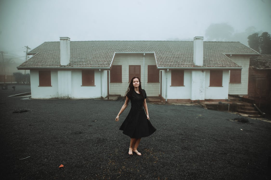 Woman Wearing Black Dress in Front of White House