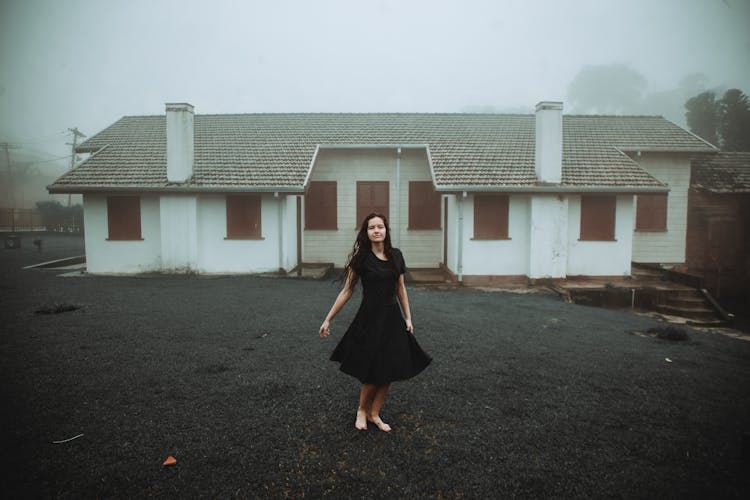 Woman Wearing Black Dress In Front Of White House