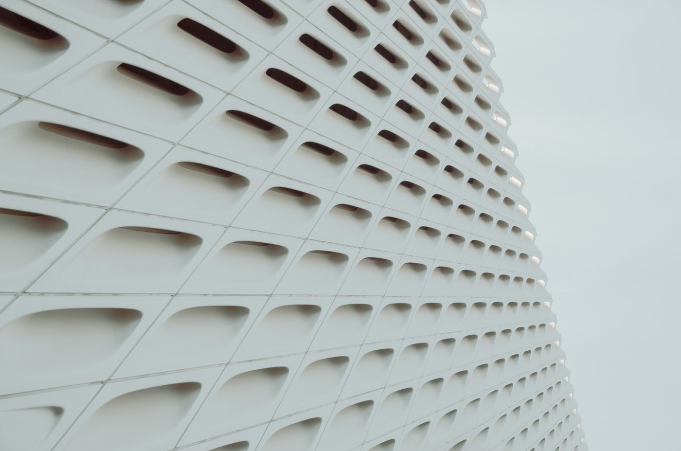 White geometric facade with a grid pattern