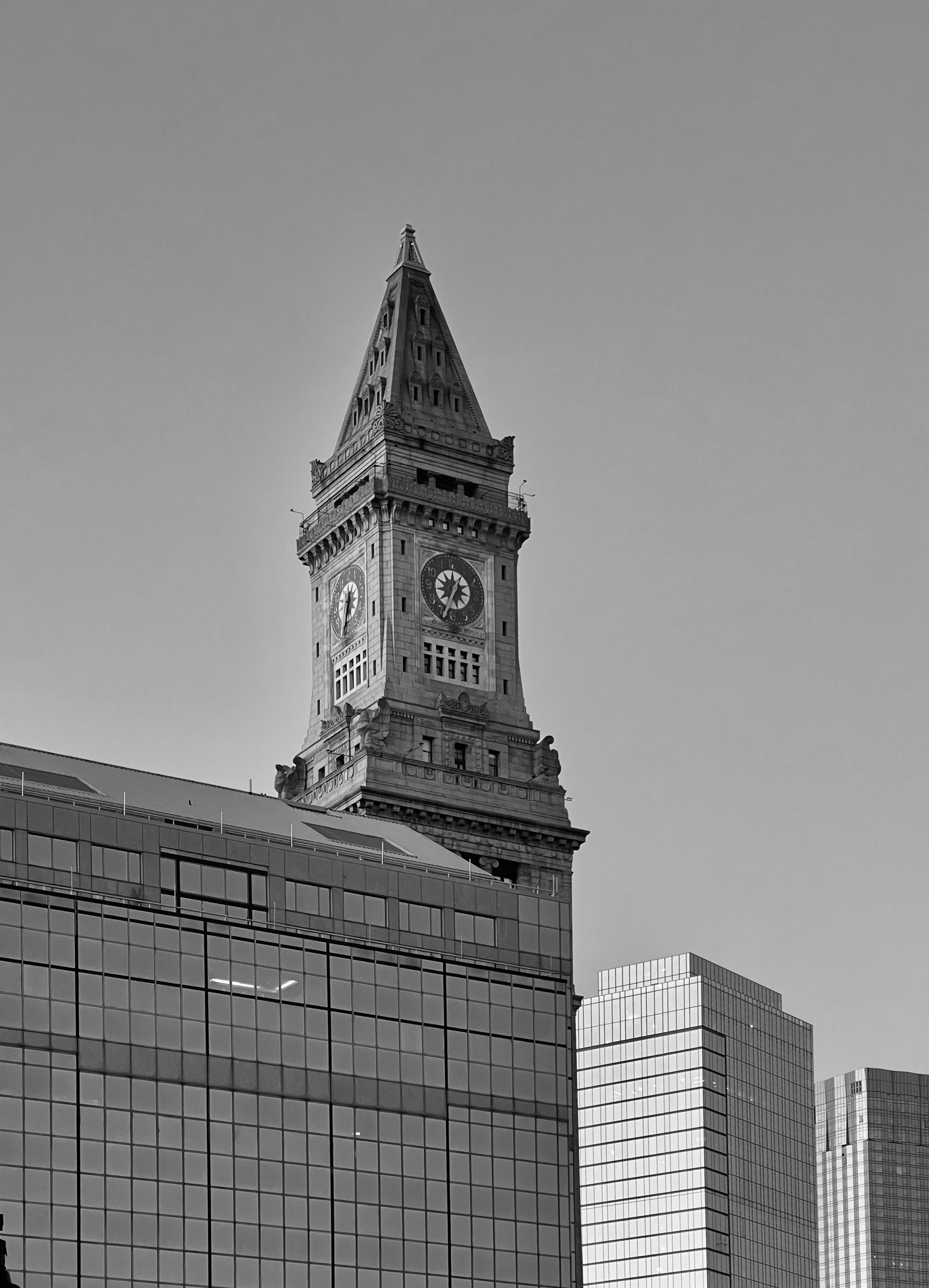 Clock Tower Against Modern Skyline in Black and White · Free Stock Photo