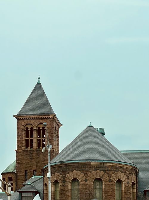 Free A historic stone church with unique architectural features under a clear sky. Stock Photo