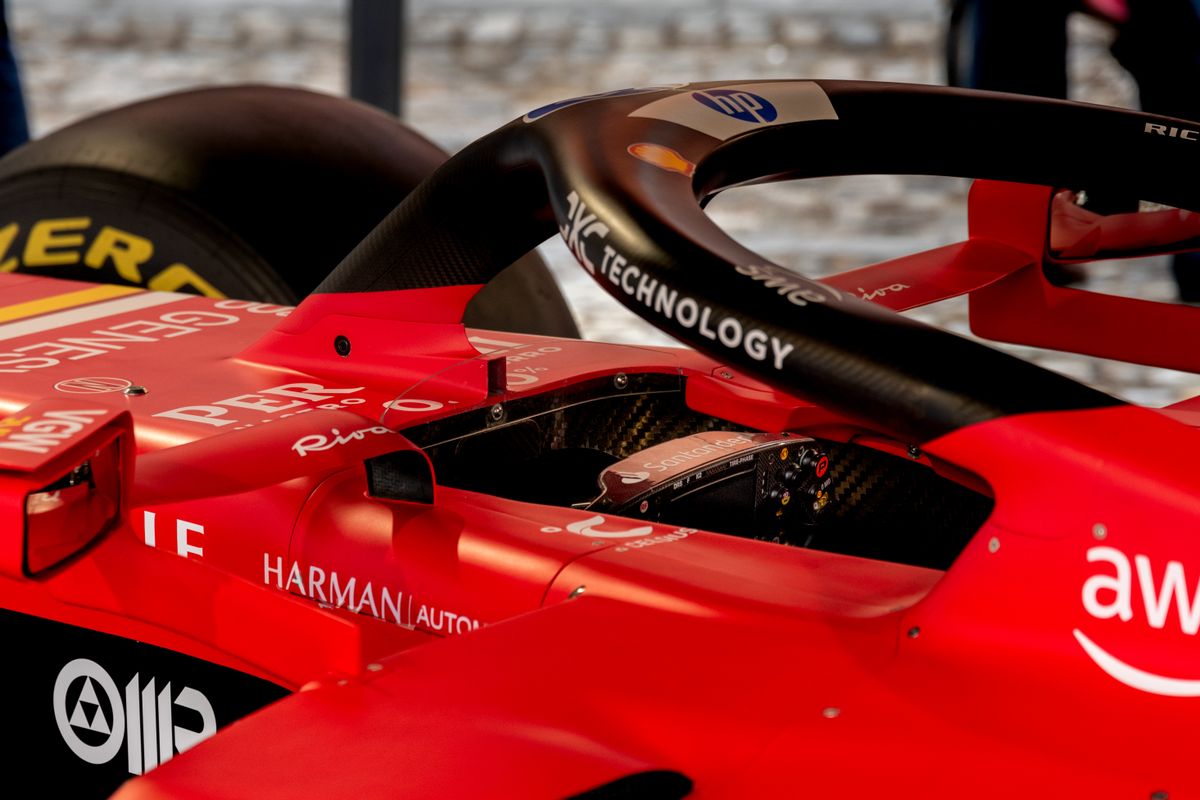 Close-up view of the nose cone and front wing of a red Formula One racing car showing the aerodynamic detail and red livery