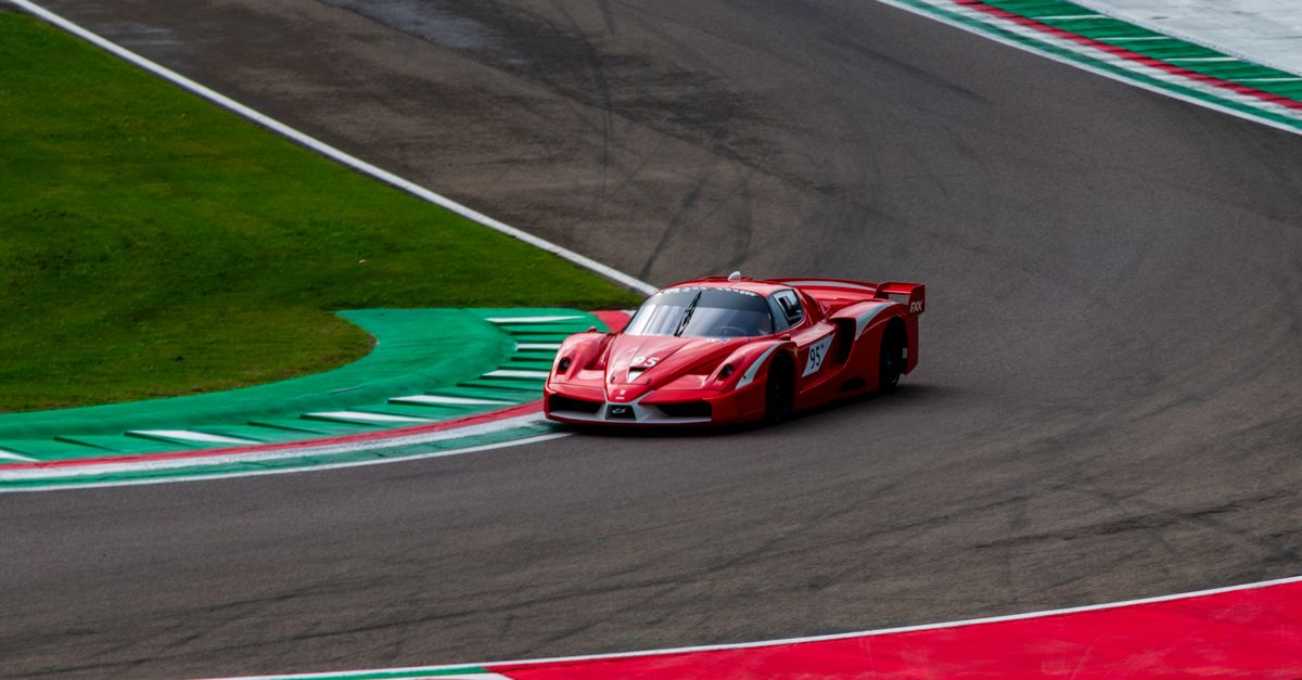 Red Racing Car On Track Red Sports Car on a Racing Track at Daytime · Free Stock Photo
