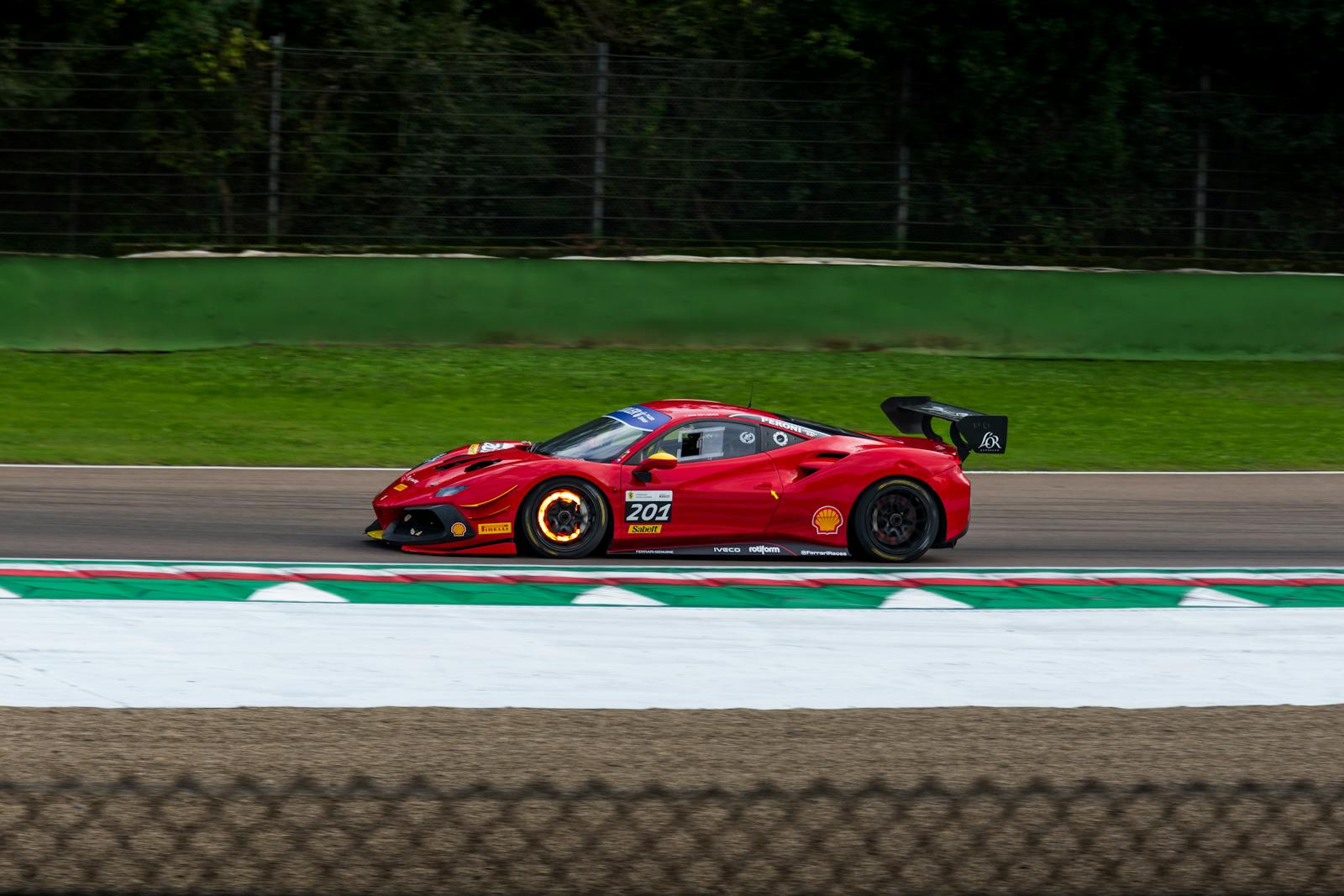 Red Racing Car on Race Track during Daytime · Free Stock Photo
