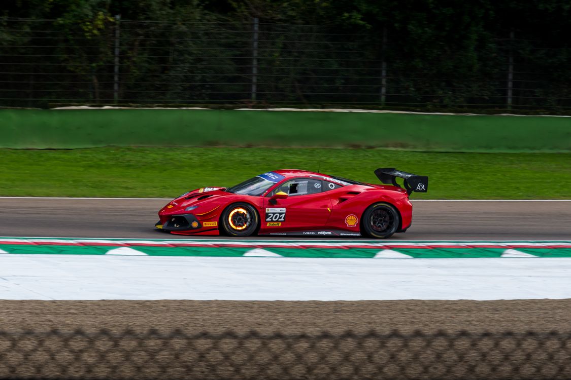 Red Sports Car Racing on Track at High Speed · Free Stock Photo