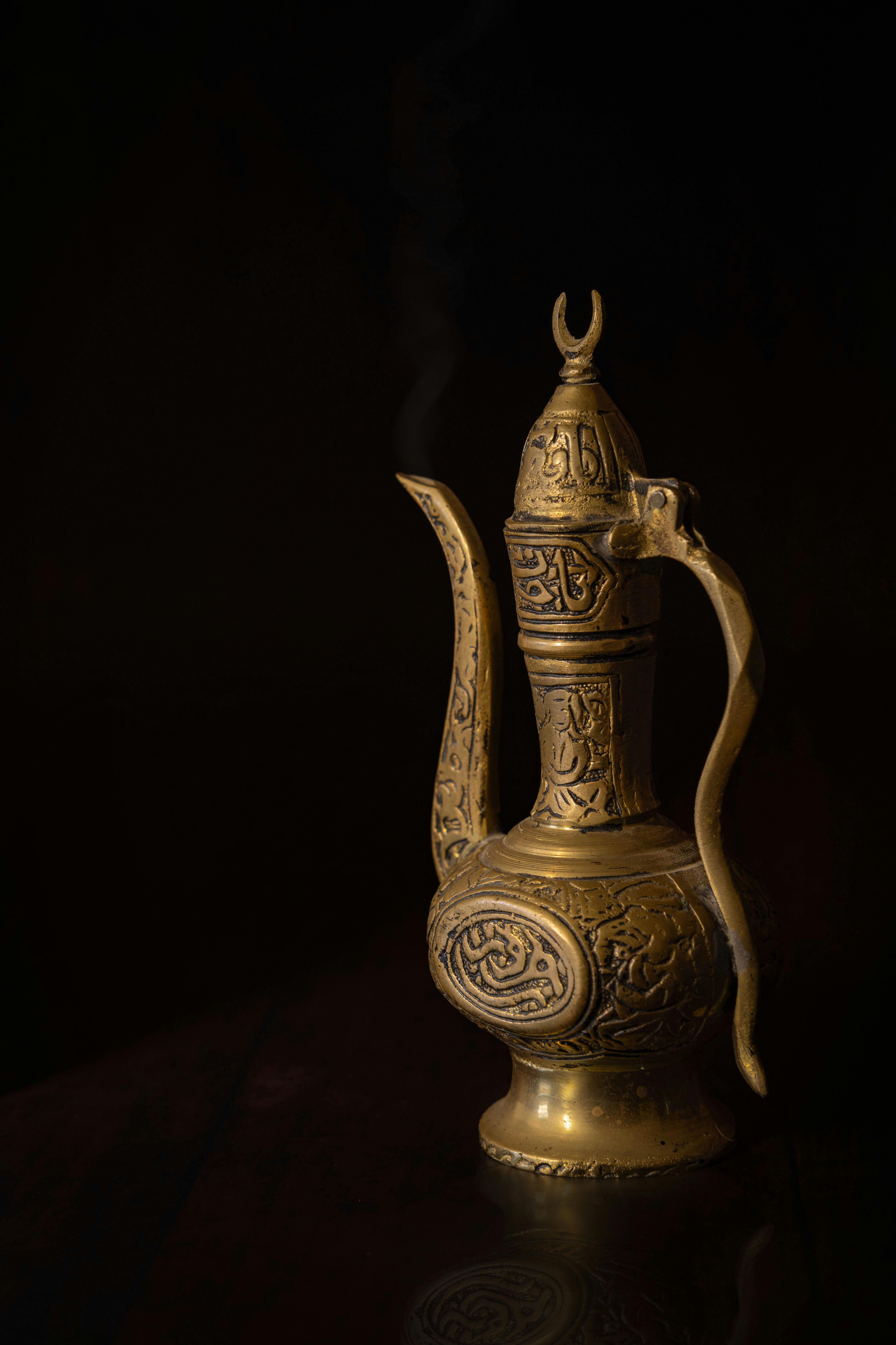 golden ornate vintage brass teapot on display