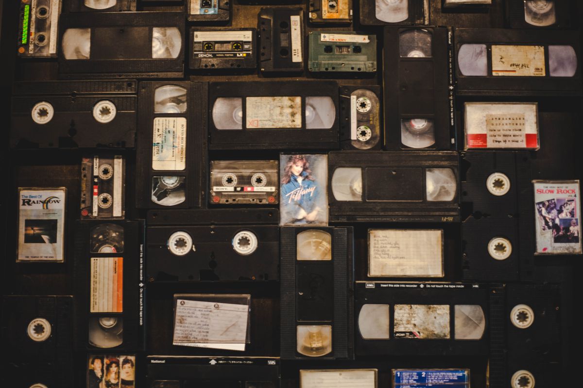 Shelves of vintage VHS video cassette tapes from the 1980s and 1990s