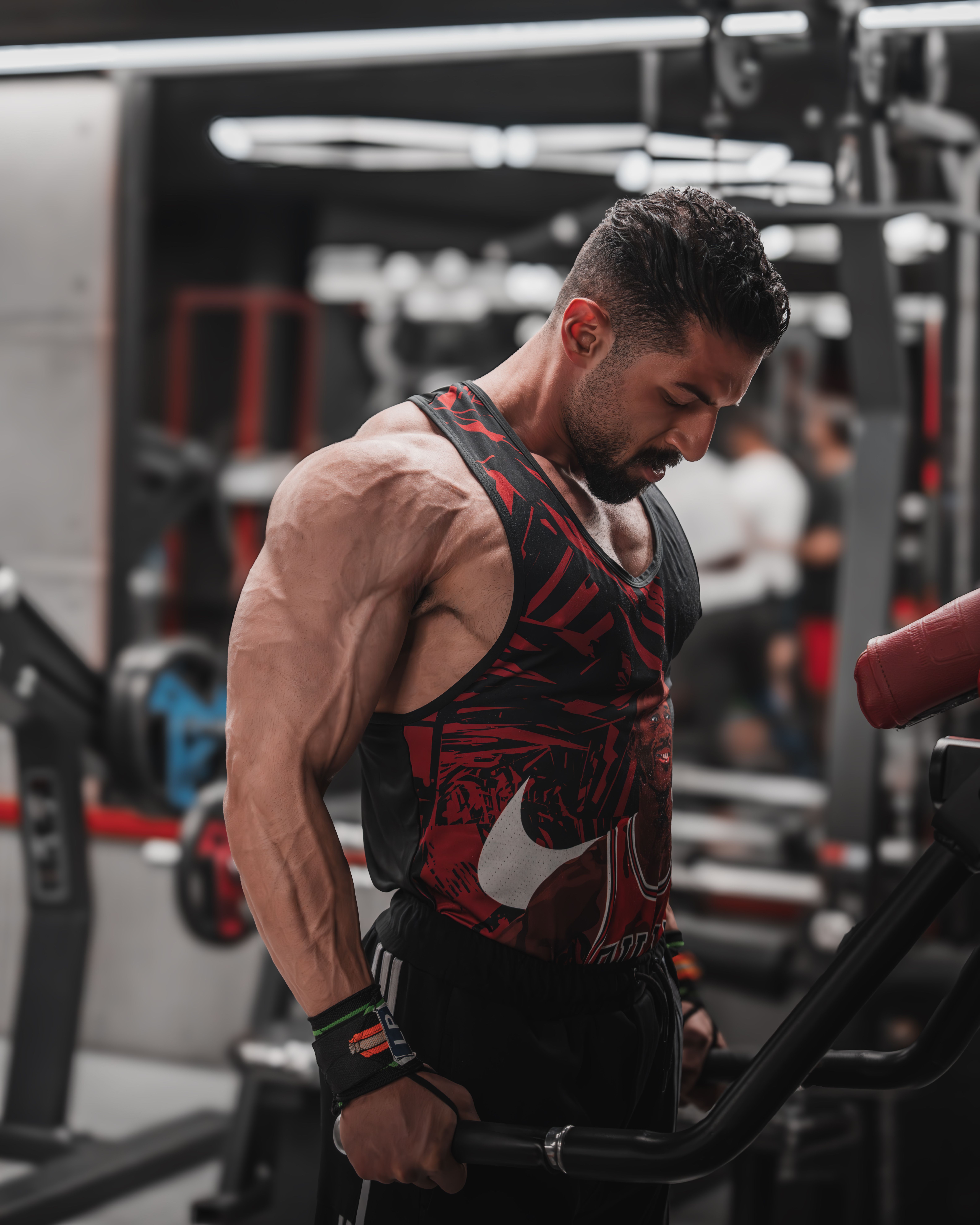 Muscular man engaged in fitness training at an upscale gym.