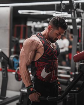 Muscular man engaged in fitness training at an upscale gym.