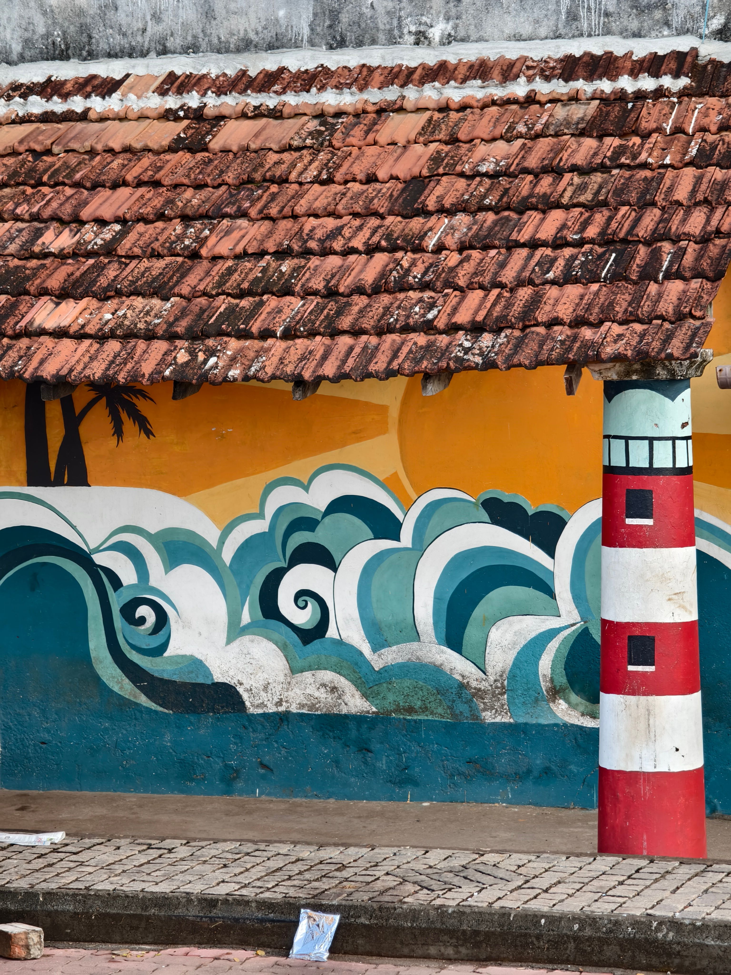 colorful-mural-of-waves-and-lighthouse-on-wall-free-stock-photo
