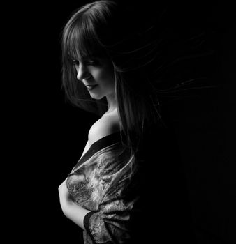 Artistic black and white portrait of a woman wrapped in fabric, showcasing elegance.
