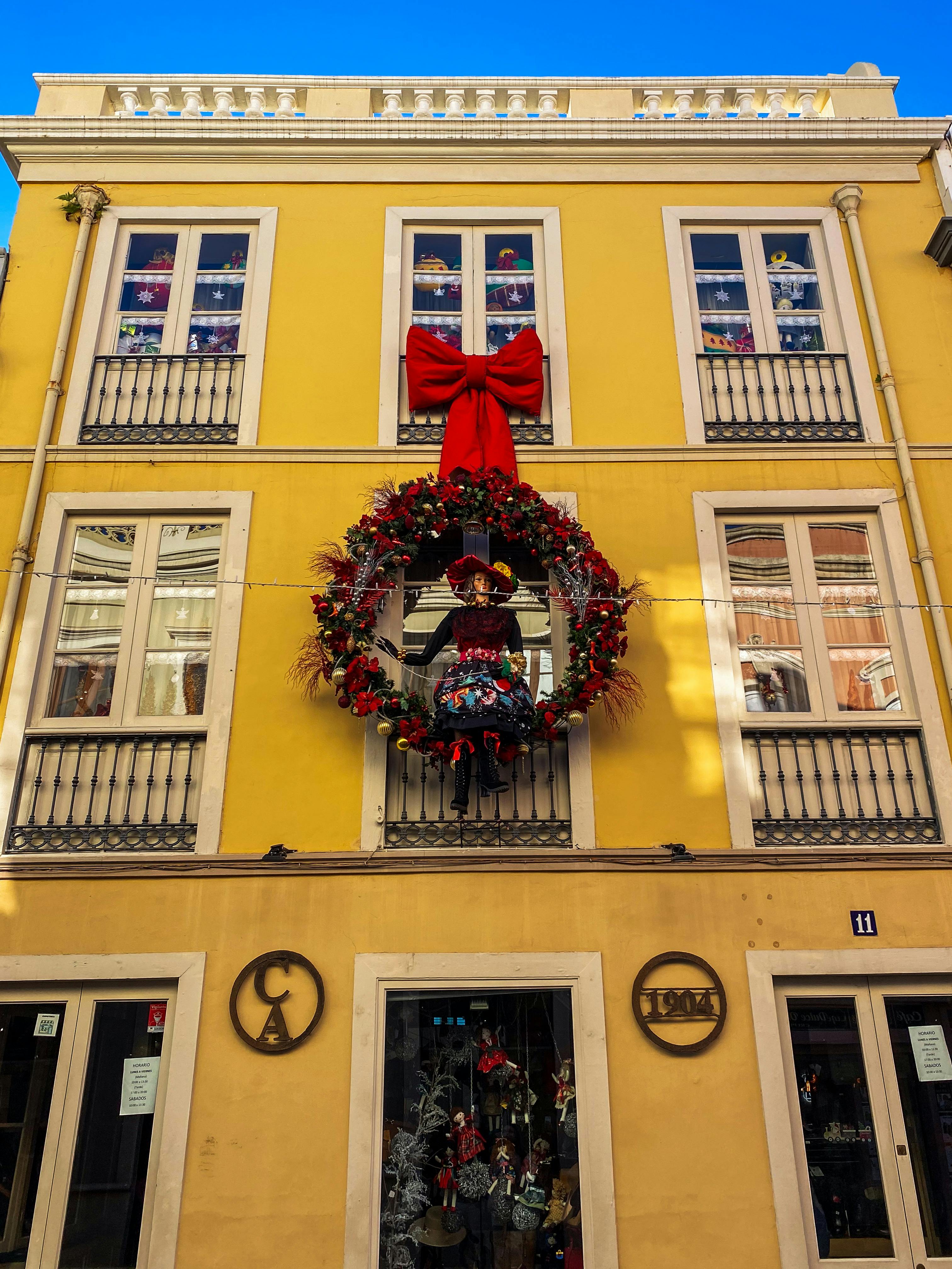 colorful christmas wreath on spanish building