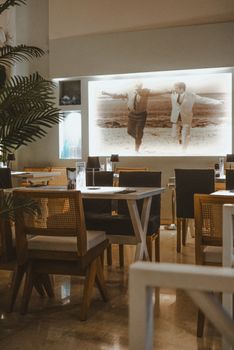 A warm and inviting restaurant interior with vintage-style decor and empty seating.