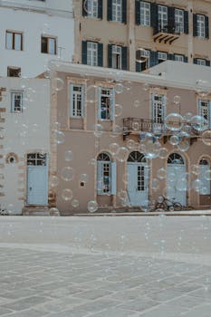 Charming scene with bubbles in front of a classic European architecture.