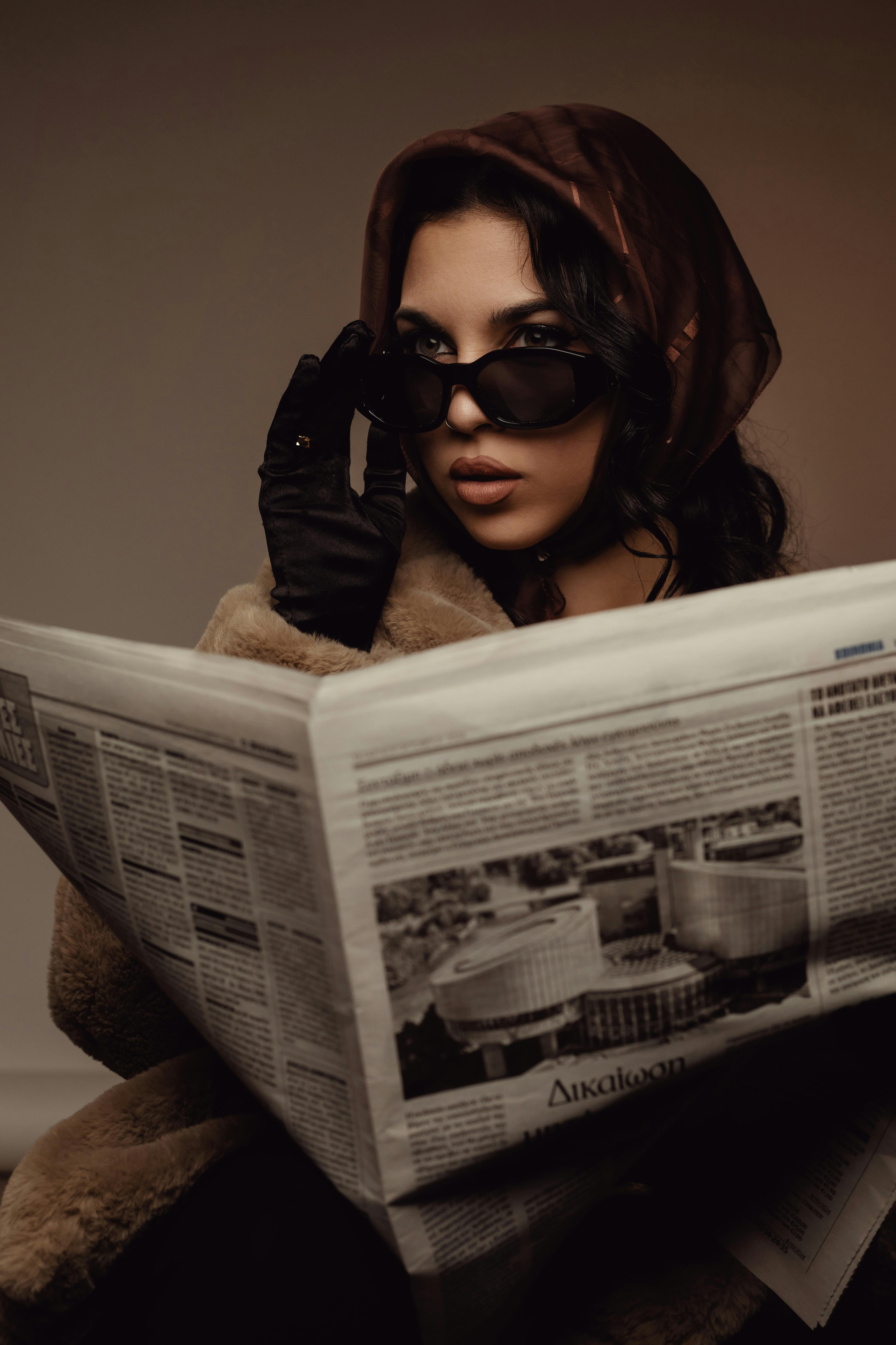 stylish woman reading newspaper indoors