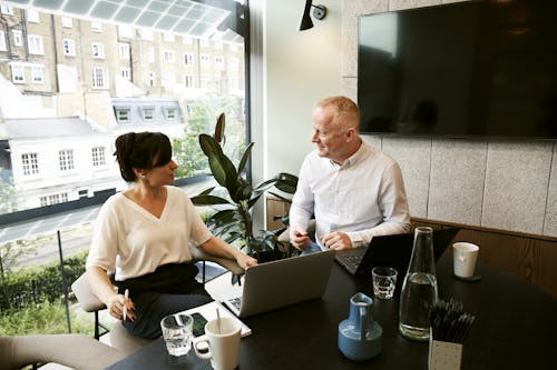 Free Man and Woman Discussing And Sharing Ideas Stock Photo