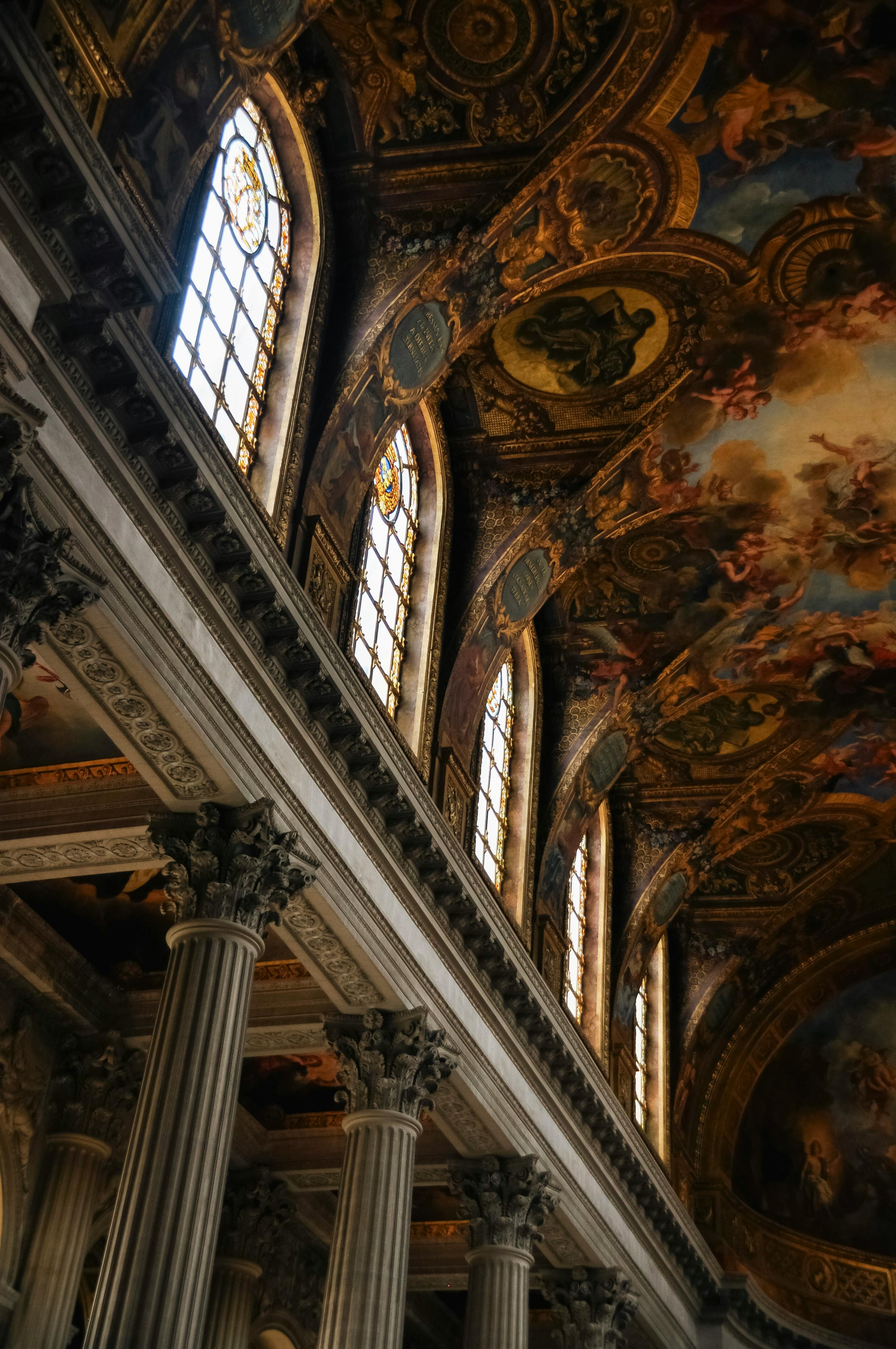 Explore the ornate ceilings and columns of Versailles Palace's regal interior.