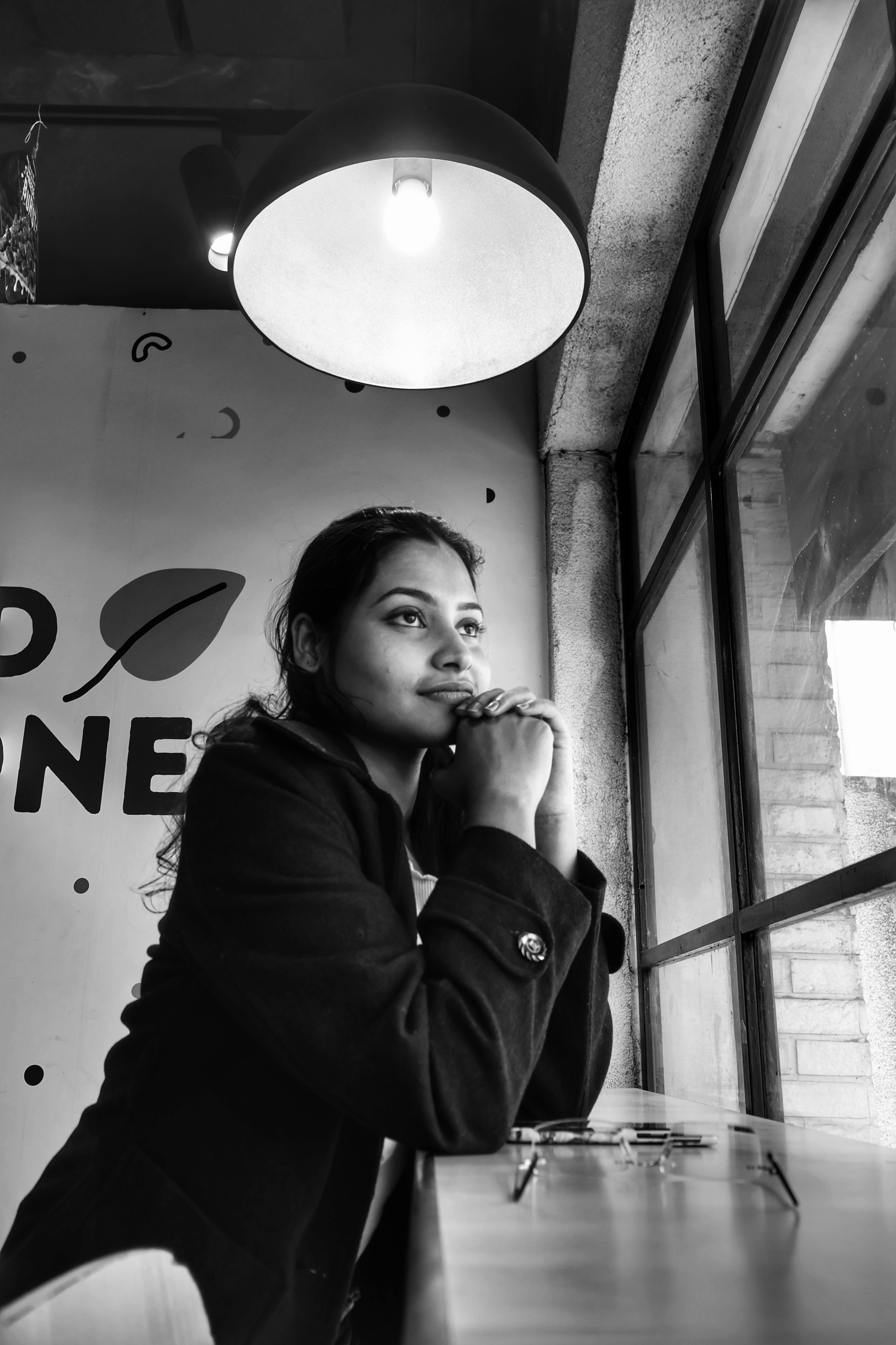 contemplative woman in cafe with window view