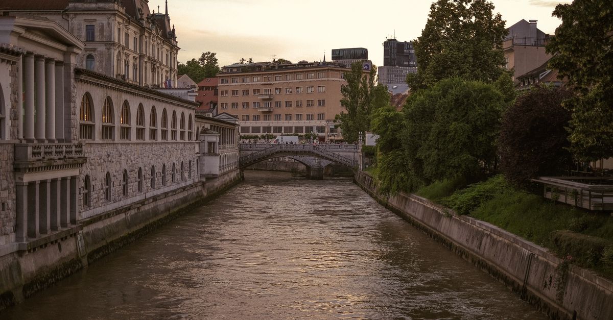 A sunset view over Ljubljana Castle with the river and bridges below