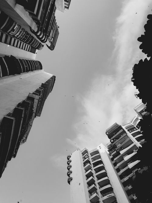 Free Monochrome view of high-rise buildings from a low angle with sky background Stock Photo