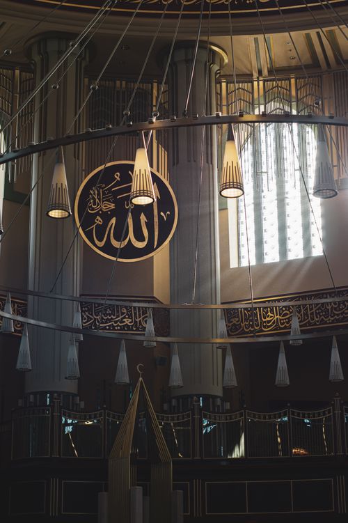Free A beautiful mosque interior showcasing Islamic calligraphy and architectural design. Stock Photo