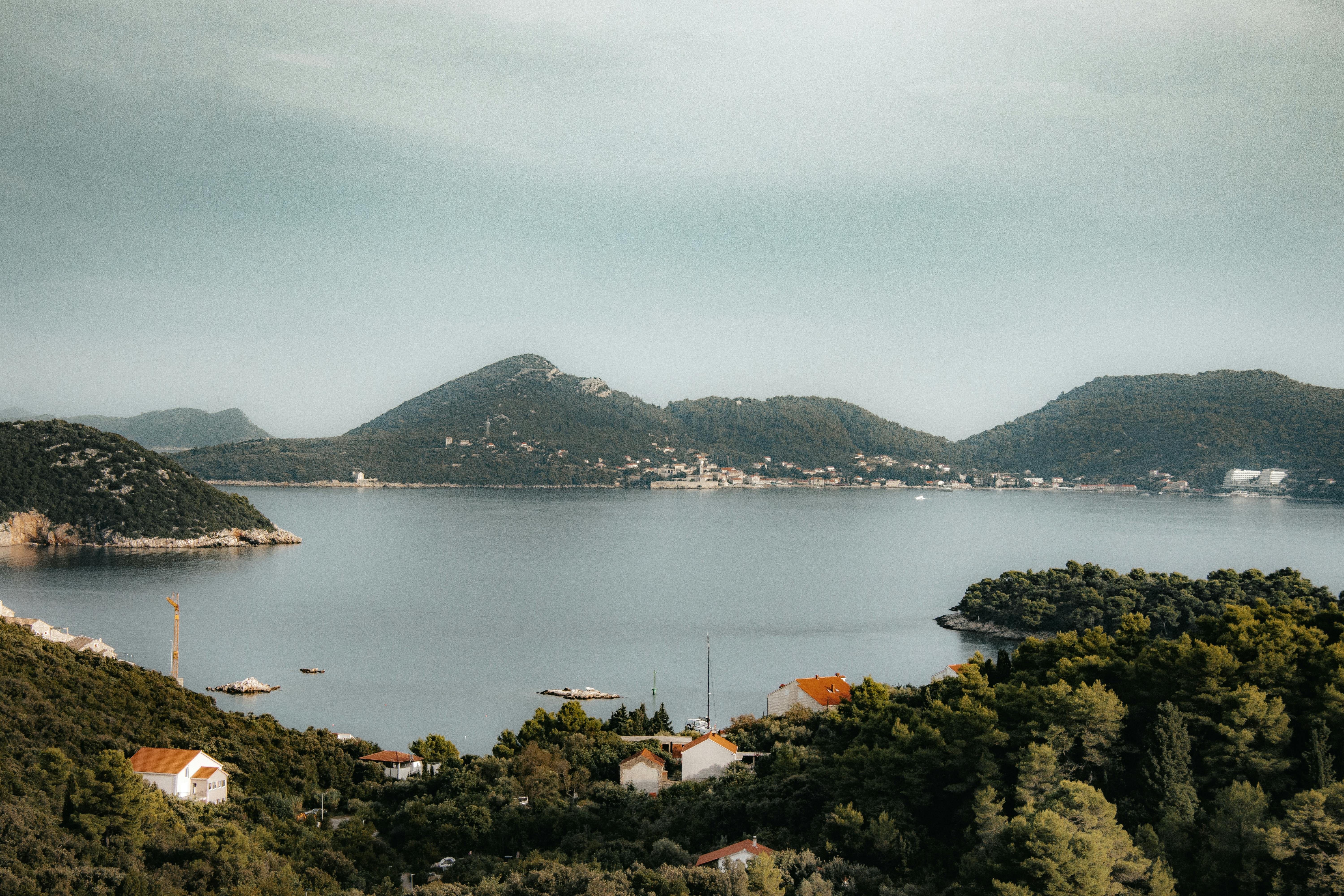 A serene landscape of Lopud Island, Croatia, captured in summer with lush greenery and calm waters.