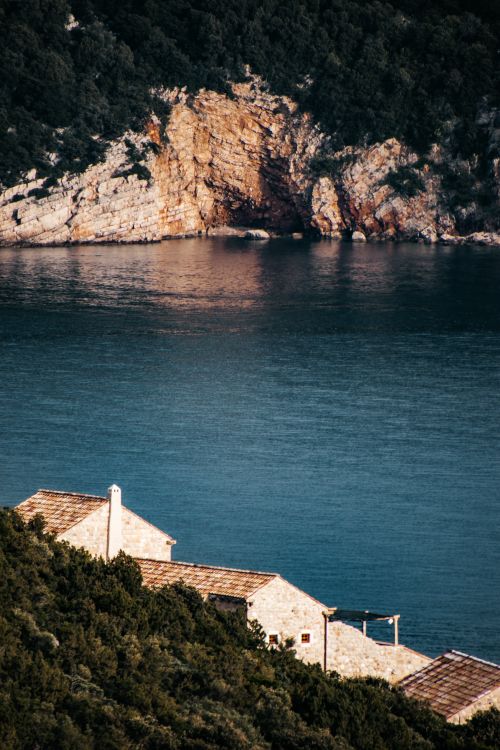 Free Idyllic view of Lopud Island's coastline in Dubrovnik, Croatia, with a rocky cliff and clear blue water. Stock Photo