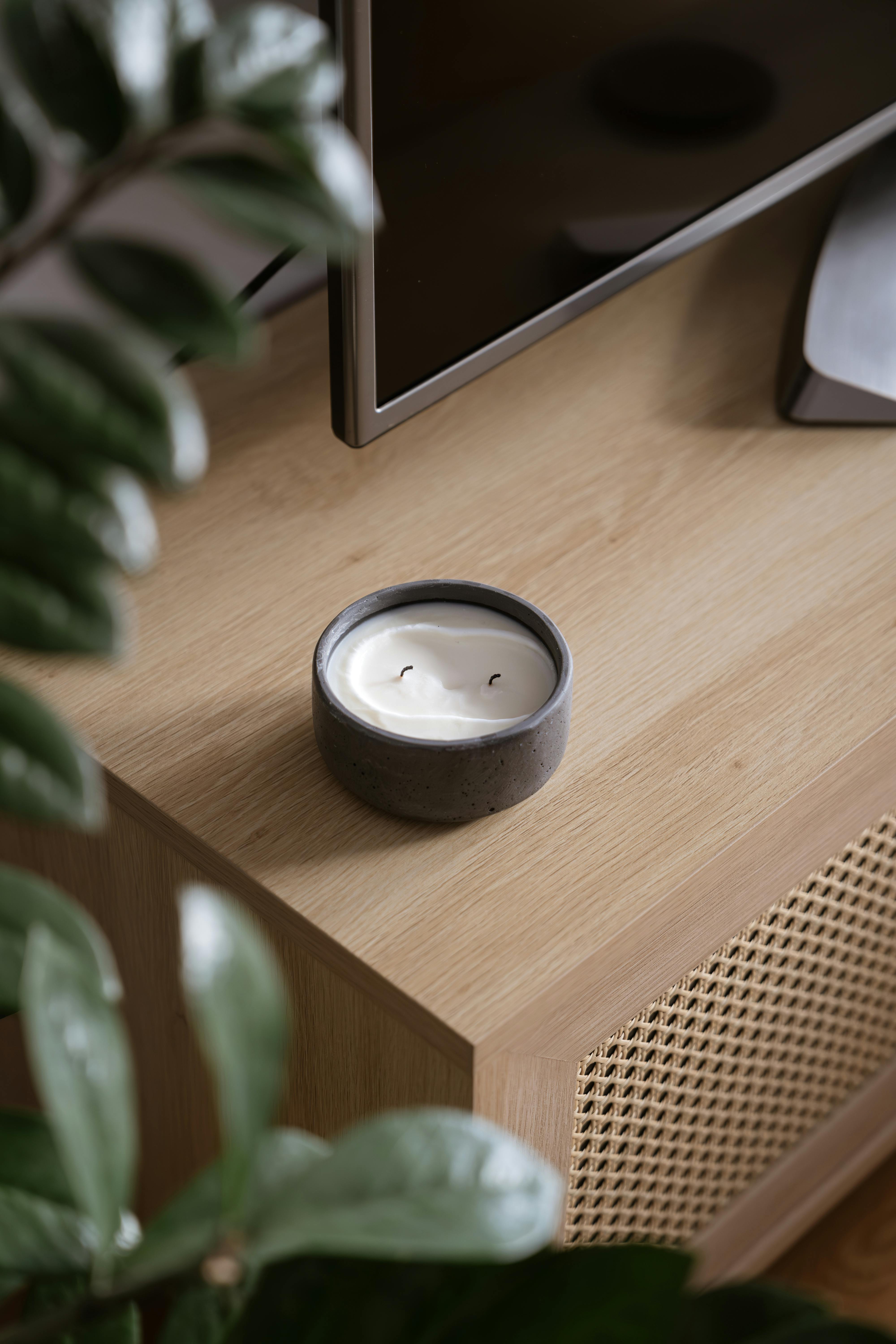 A cozy living room scene featuring a minimalist decor with a candle.