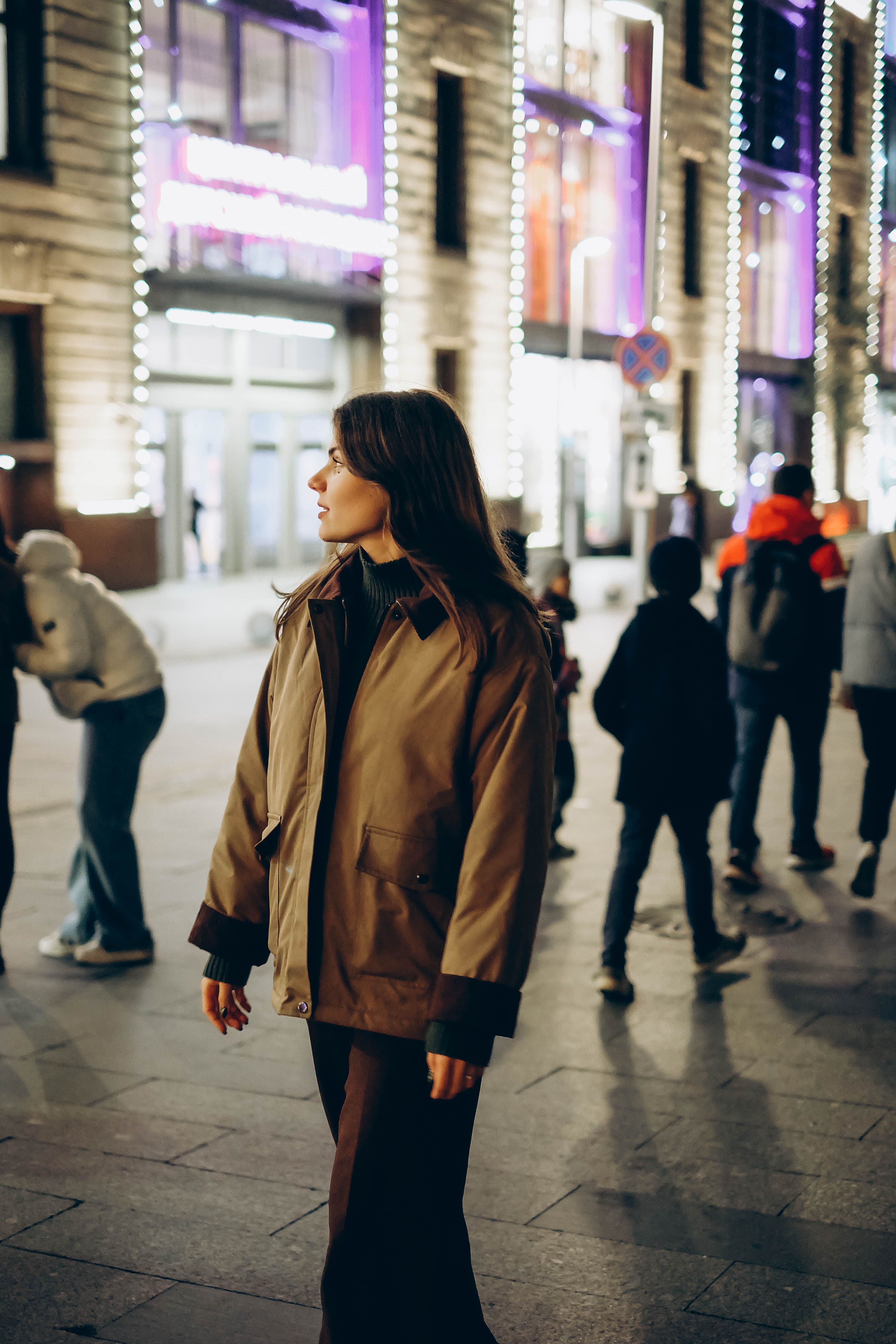 Woman Strolling Through Vibrant City Street at Night · Free Stock Photo