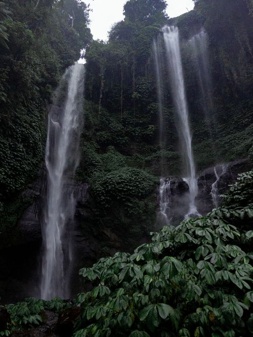 Free Stunning twin waterfalls cascade in Bali's lush tropical jungle, a serene natural marvel. Stock Photo
