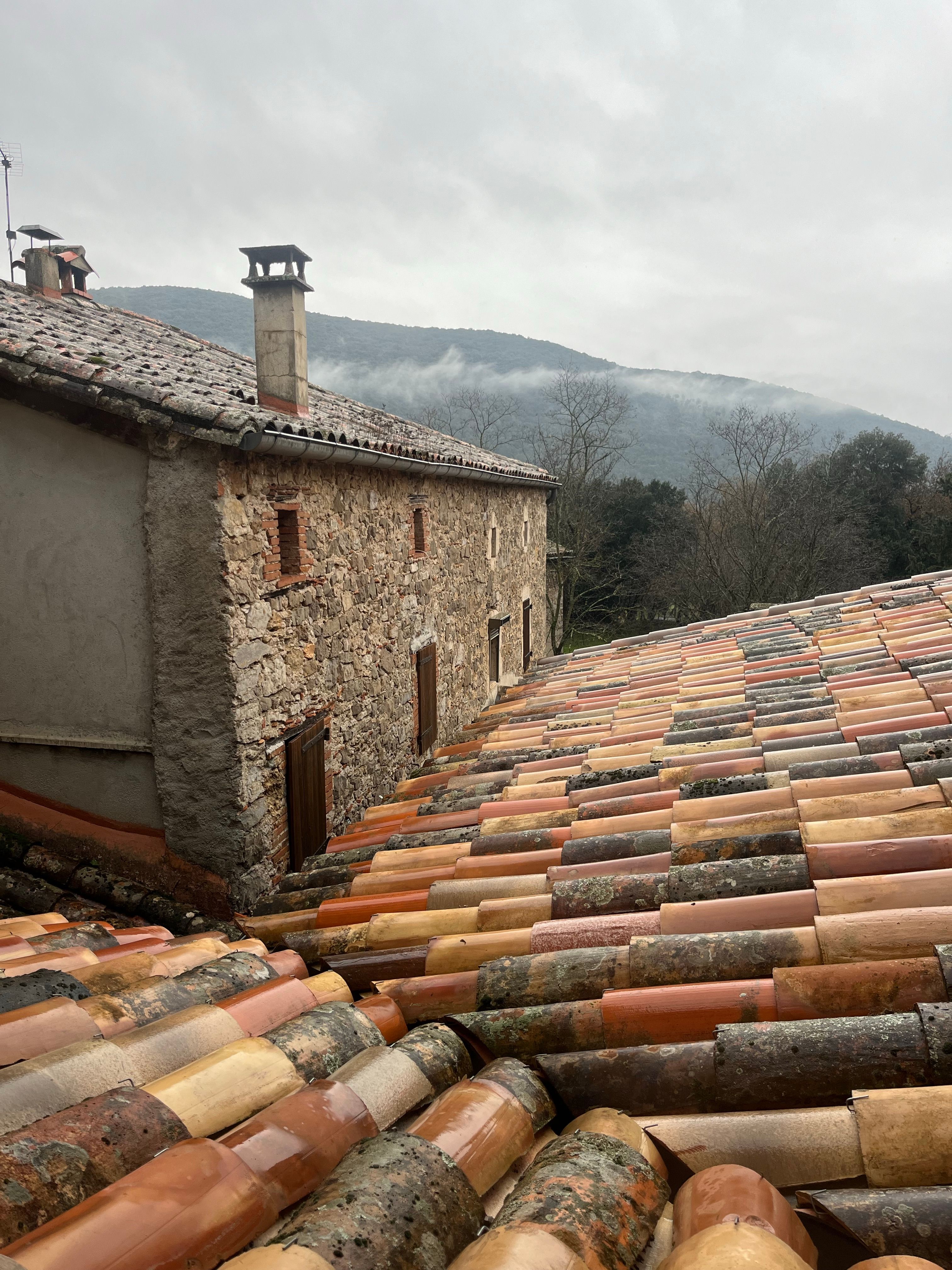 Rustic Stone House with Colorful Rooftop View · Free Stock Photo