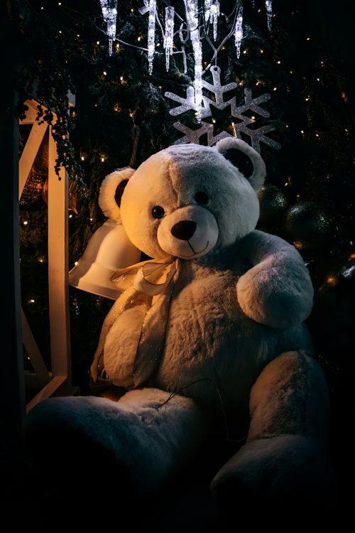 Free Warm and inviting scene featuring a teddy bear amid festive Christmas decorations. Stock Photo