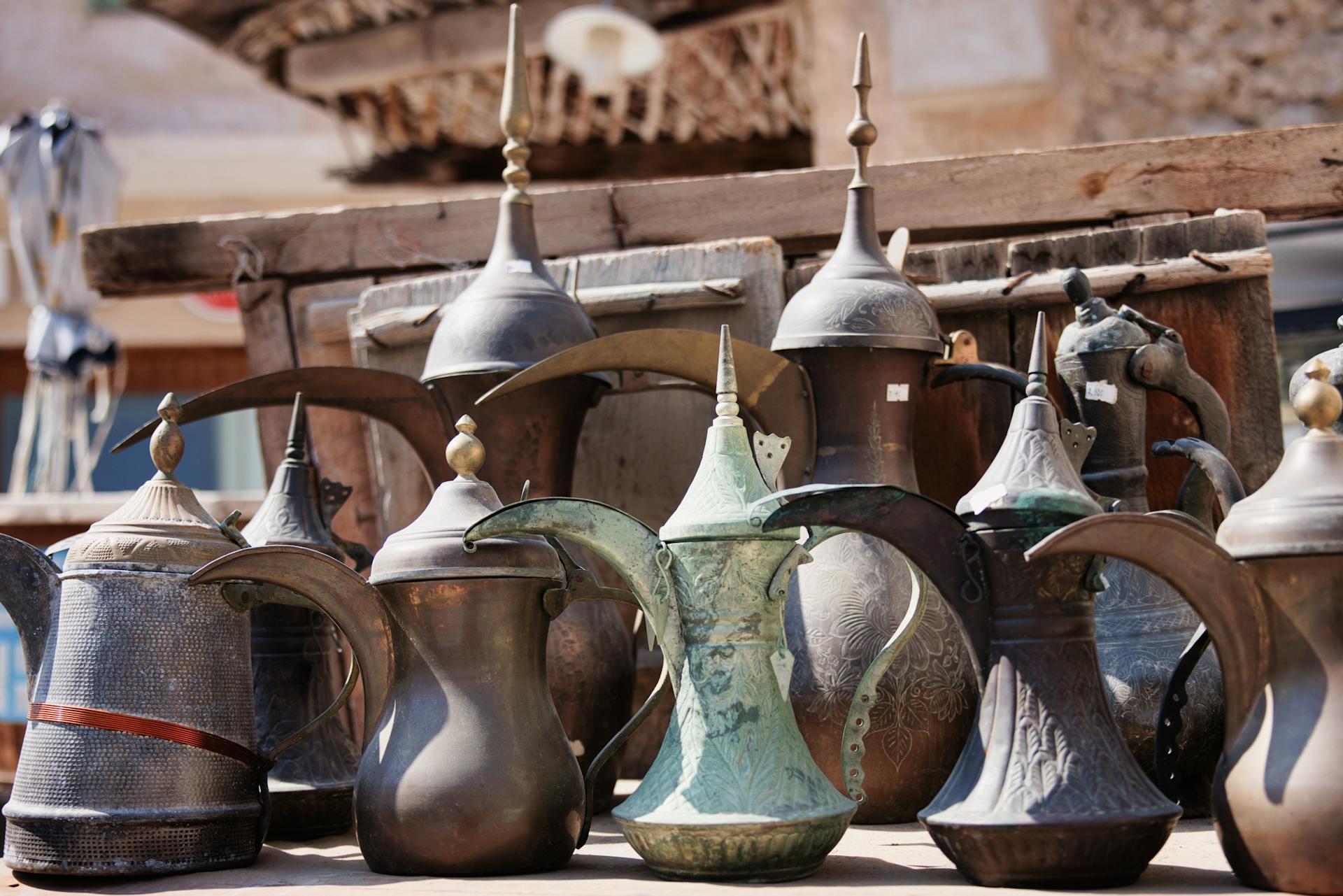 A collection of antique Dallah coffee pots displayed in a Doha market showcasing Middle Eastern culture.