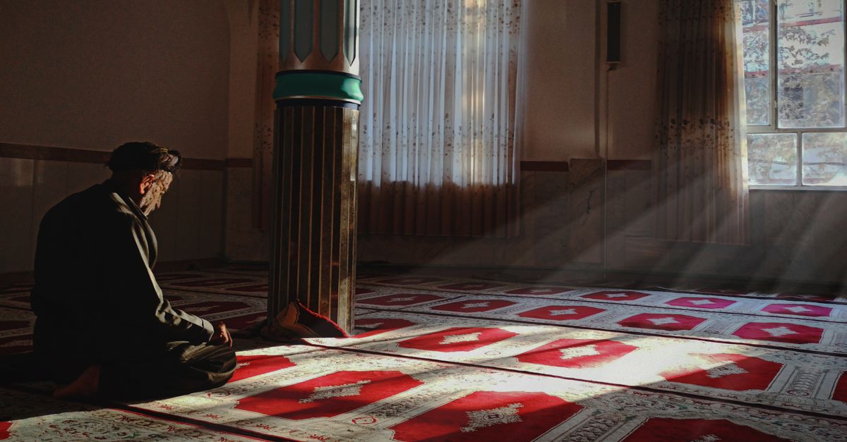 person praying peacefully in morning light