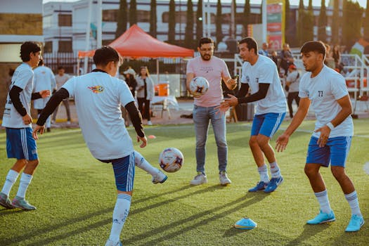 Group of young men practicing soccer drills on an outdoor field, preparing for a game.