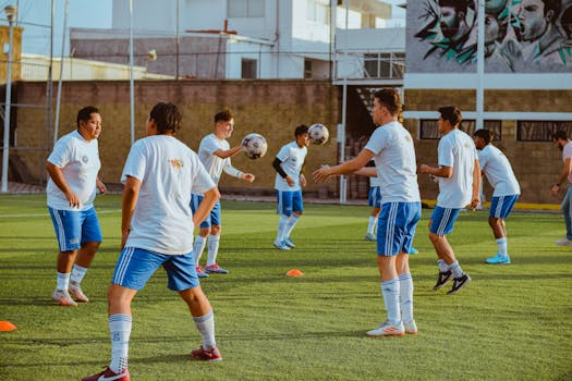 Group of young men practicing soccer on an outdoor field.