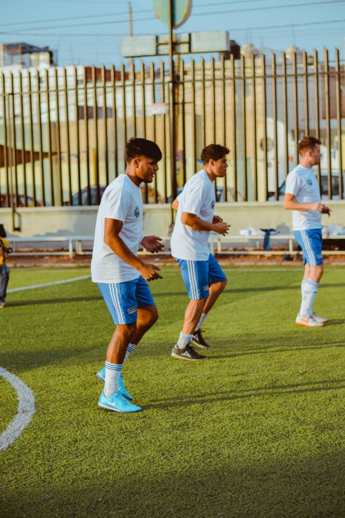 Free Group of young male soccer players training on a city field. Stock Photo