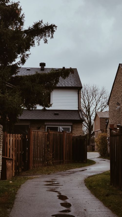 Free A quaint neighborhood pathway leading to houses in Toronto, Canada after a rainfall. Stock Photo