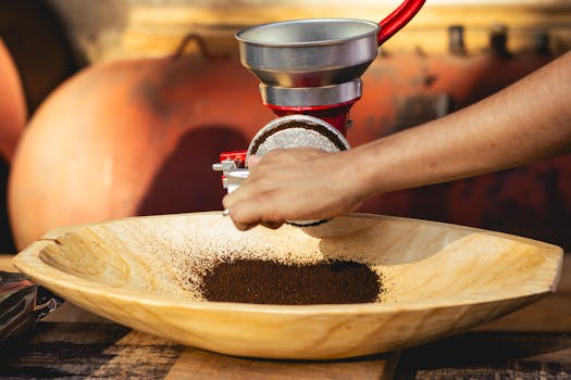 Close-up of grinding fresh coffee beans with a manual grinder, capturing authentic Mexican coffee culture.