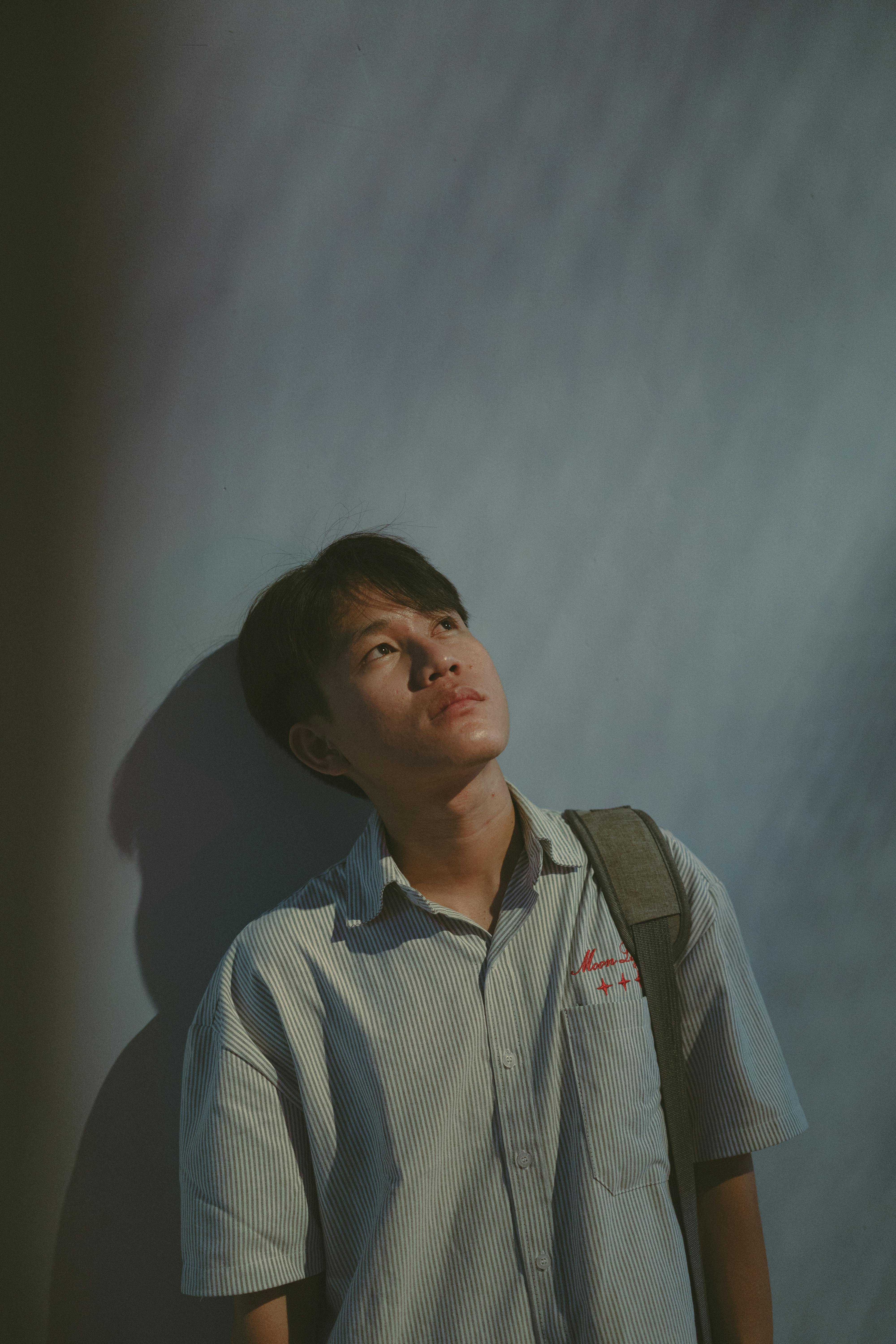 young man leaning against wall in ho chi minh city