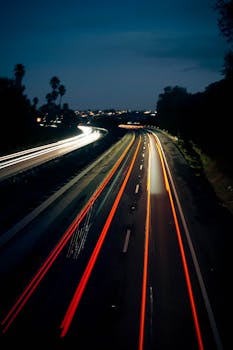 Stunning long exposure capturing light trails on a highway at twilight in Pismo Beach, California.