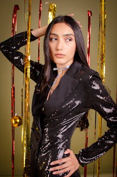 A fashionable woman in a sequin jacket poses with festive decorations.