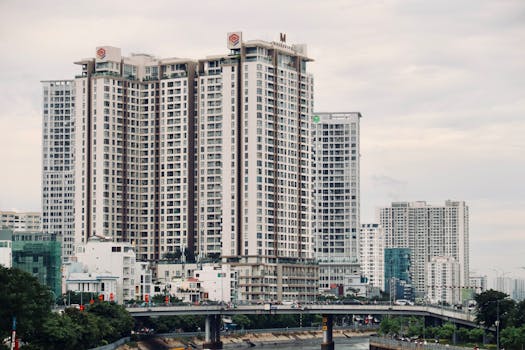 A wide-angle view of tall residential buildings in an urban setting under a cloudy sky.