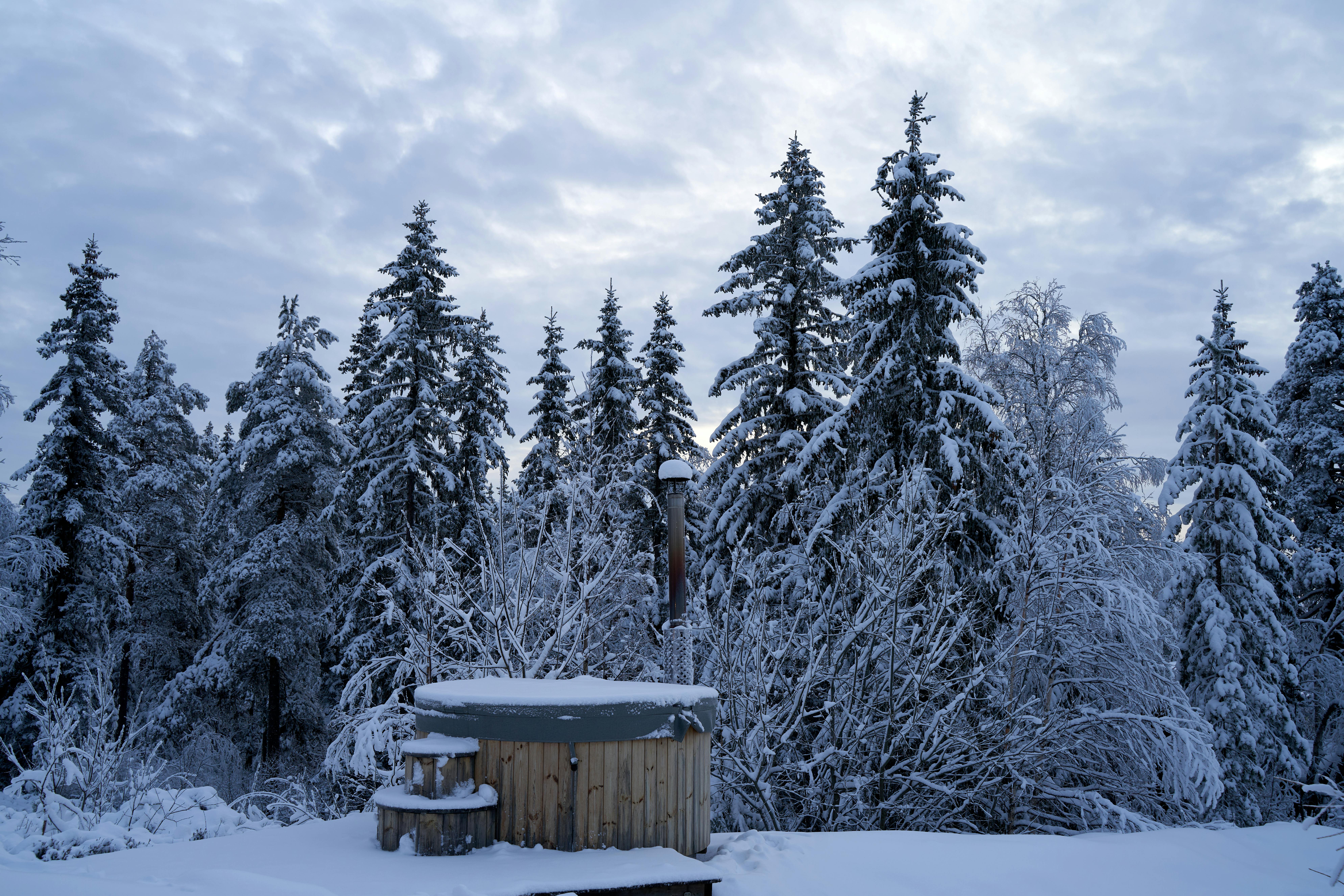 Wooden hot tub in snowy winter forest in the Poconos