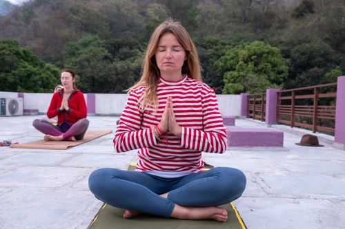 Free Two women meditating outdoors in a peaceful yoga session. Stock Photo