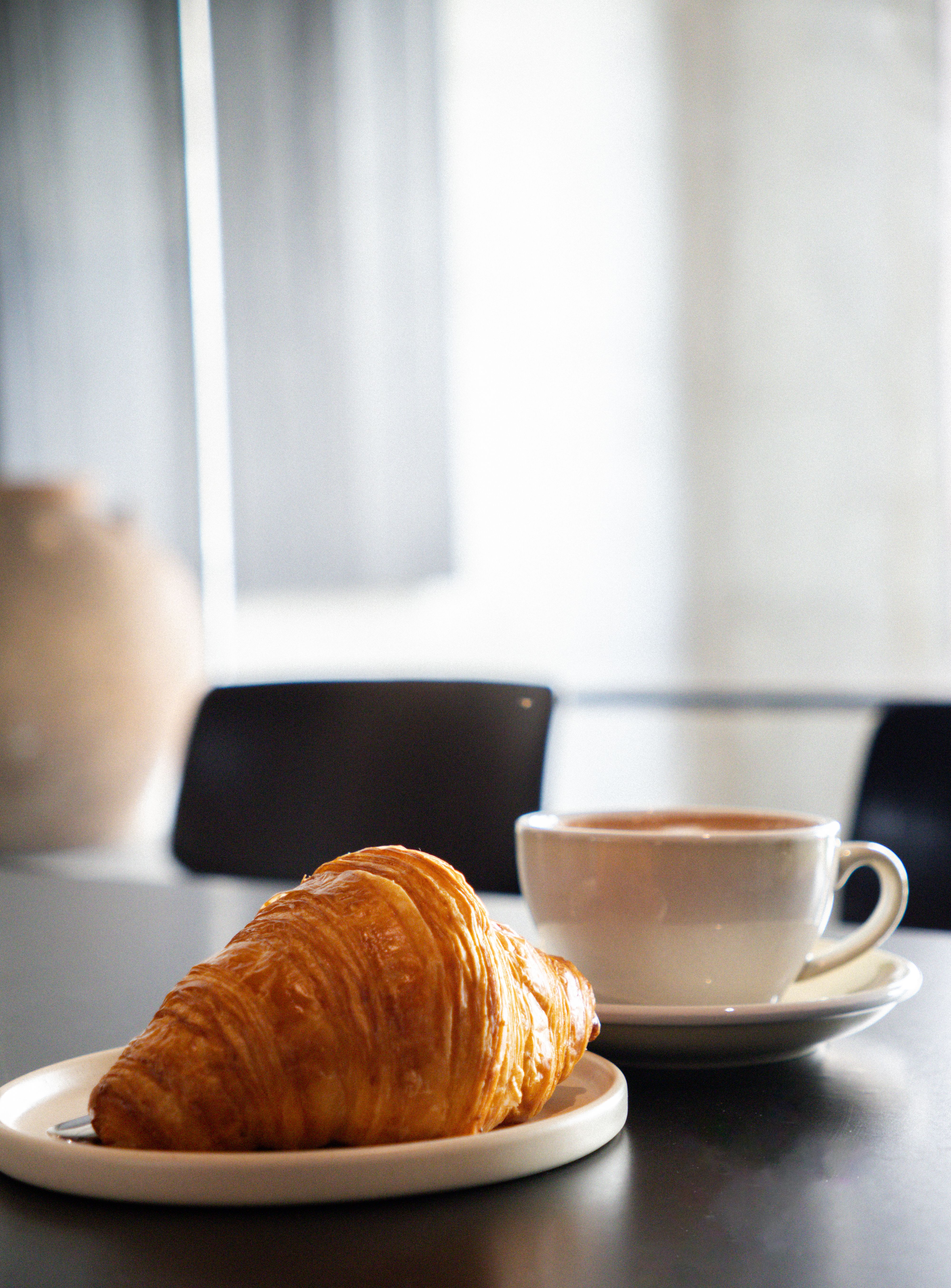 Cozy Cafe Breakfast with Croissant and Coffee · Free Stock Photo